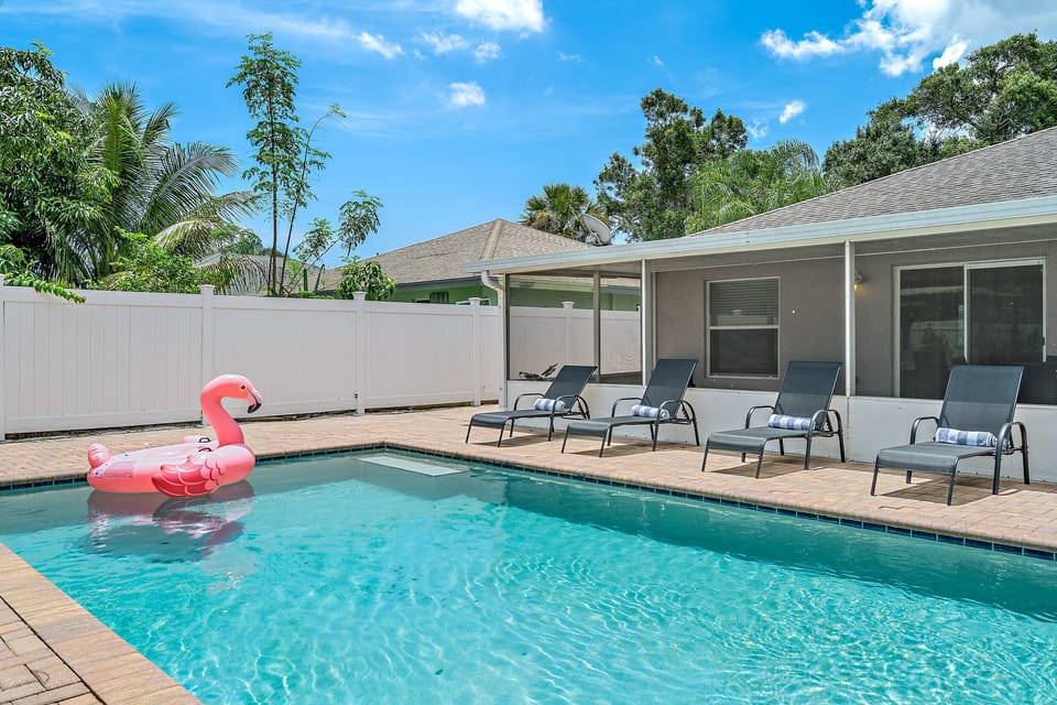 Huge pool with 4 lounge chairs to relax in the sun.