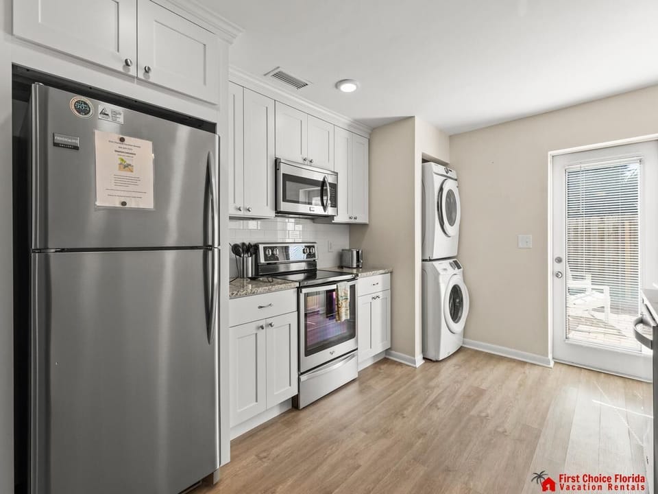 Bright kitchen with modern appliances and laundry area