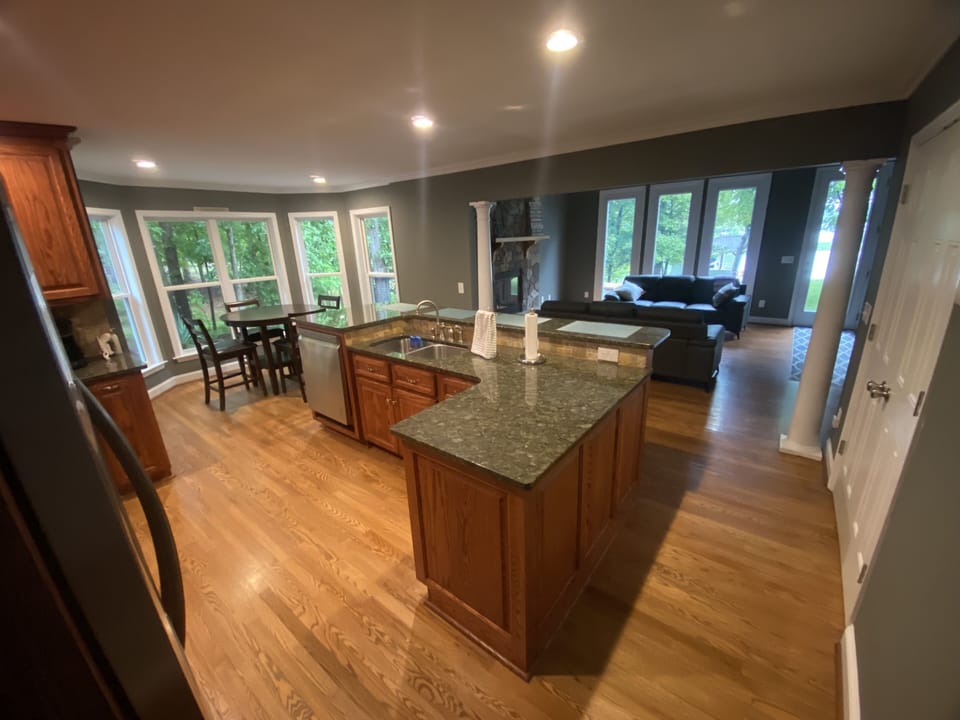 View from kitchen into large living room with gas fireplace and view of Lake.