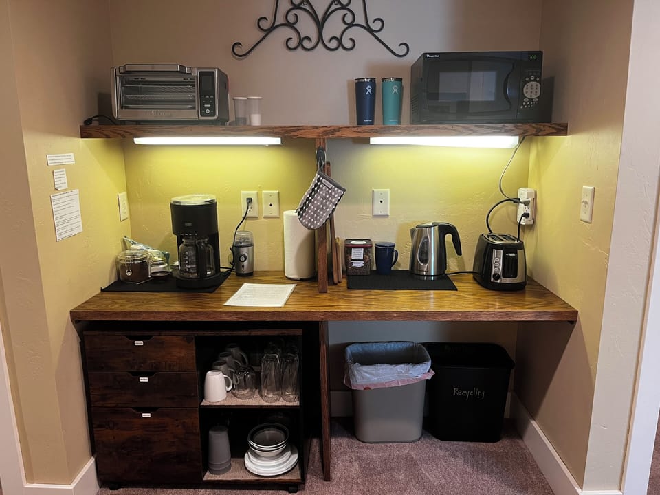 Kitchenette-microwave, tea kettle, toaster oven, coffee maker, (NO STOVE)  