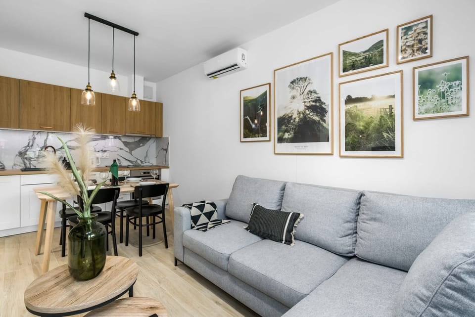 Living room with a comfortable corner sofa bed and TV.