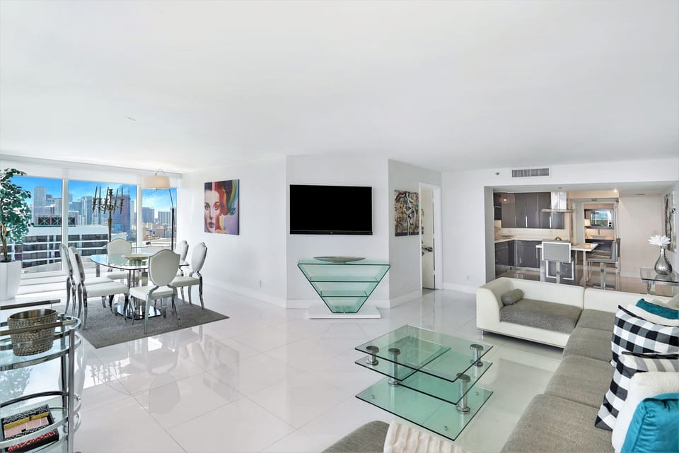 Living area, dining room, balcony access, Roku streaming tv