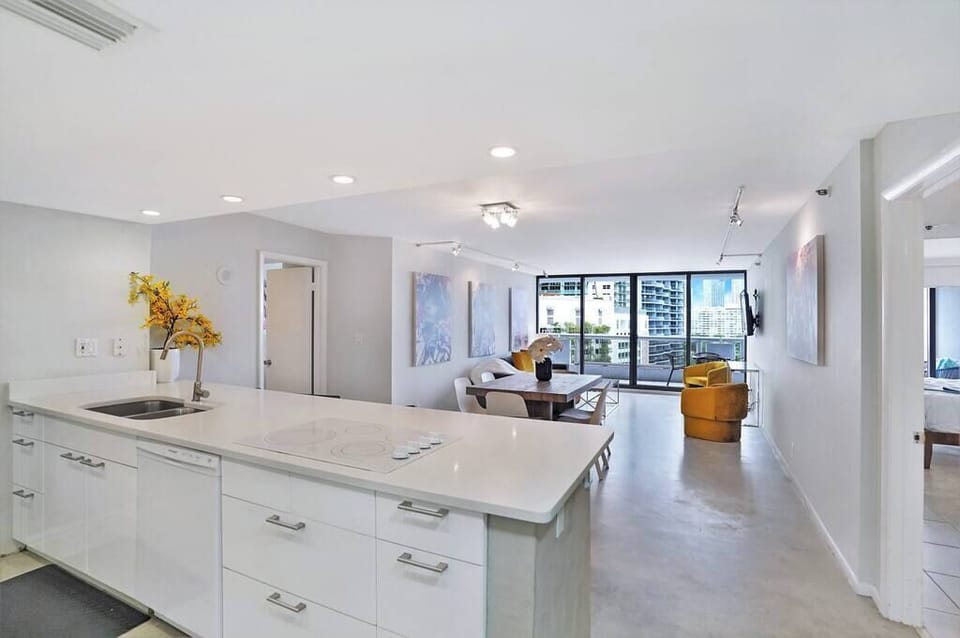 Fully equipped kitchen, living/dining area, balcony access, Roku streaming TV