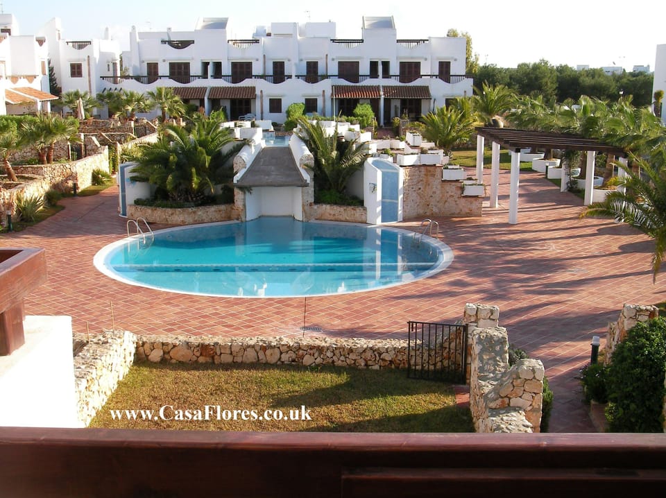 View from 1st floor balcony over shared grounds & pool.