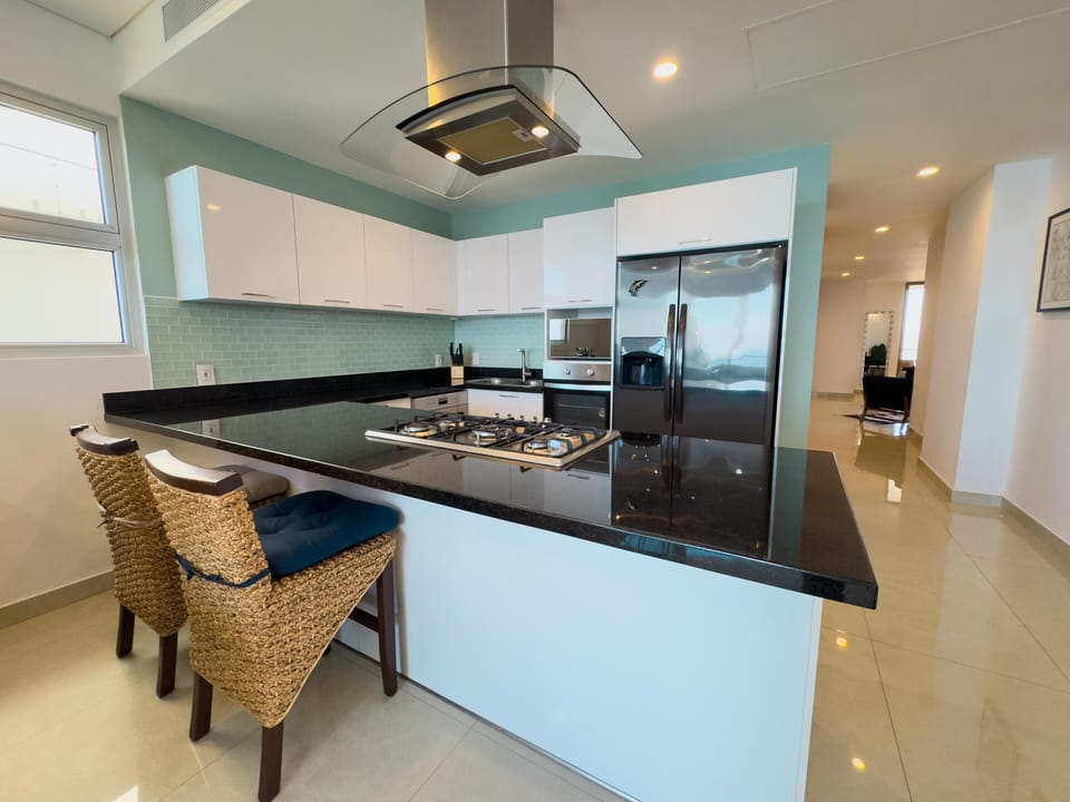Modern kitchen with sleek countertops and cozy breakfast bar seating