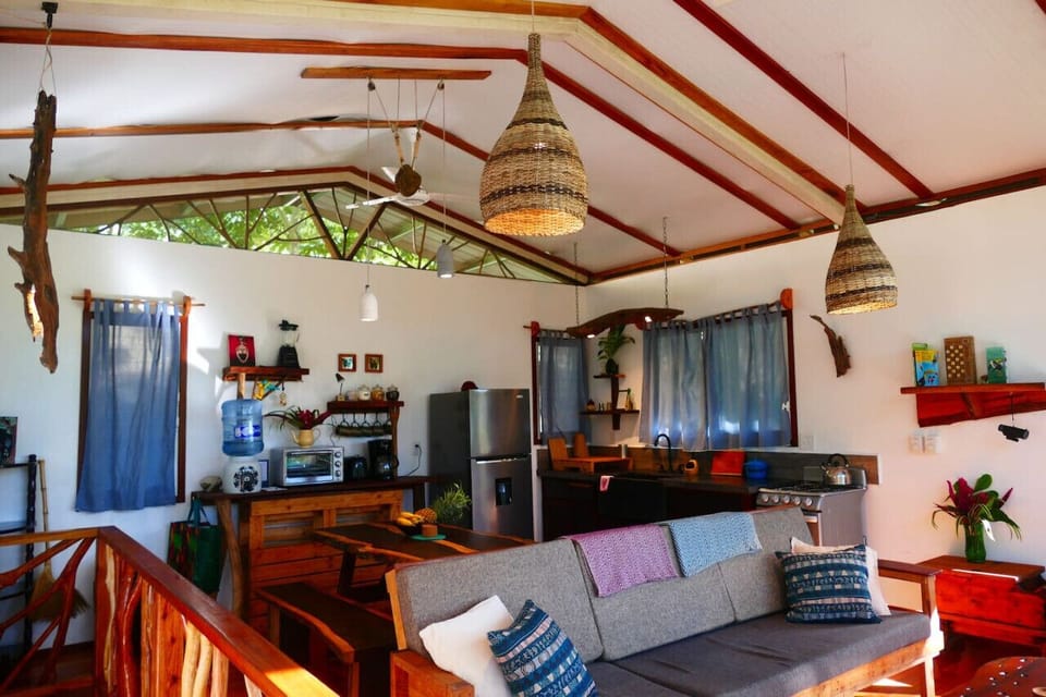 Open plan living area with river views and jungle surroundings