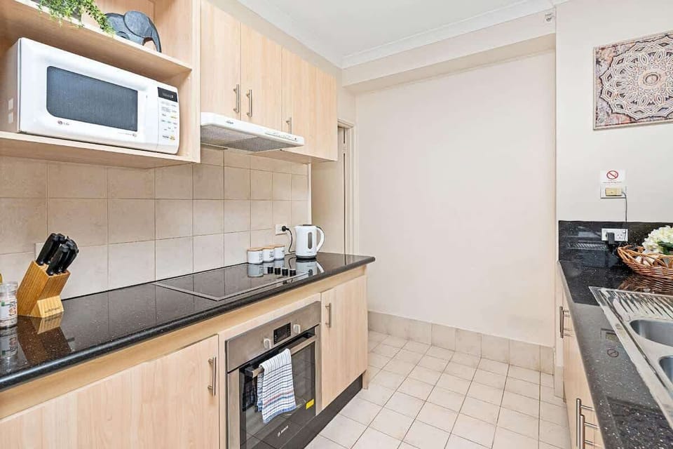 Kitchen - Crockery & cutlery provided along with basic kitchen amenities.