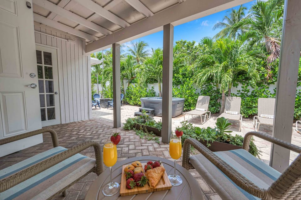 Right outside of bedroom to is a covered seating area for 2 with a view of the fire pit and hot tub!