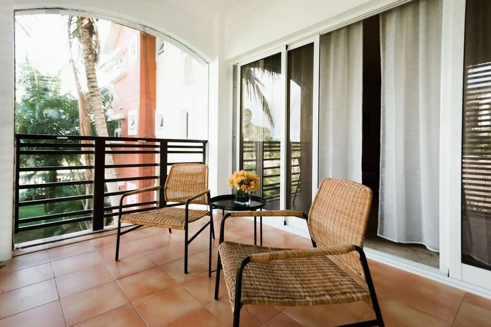 Terrace outside living room area with view to the swimming pool 