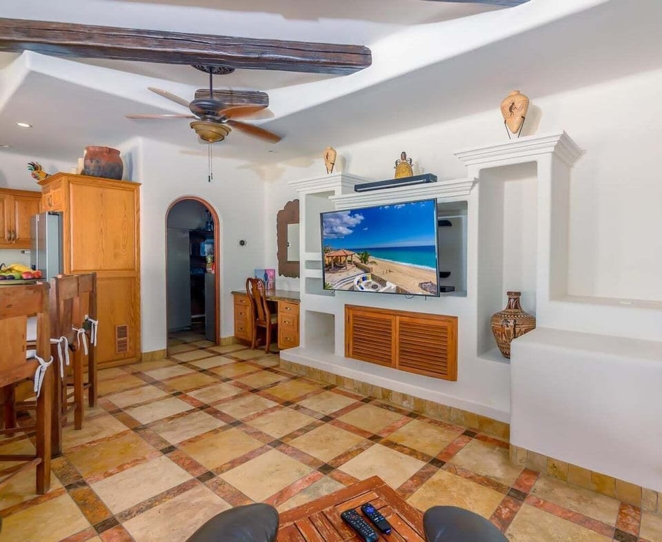Cozy living area with entertainment center, TV, and warm wooden details.