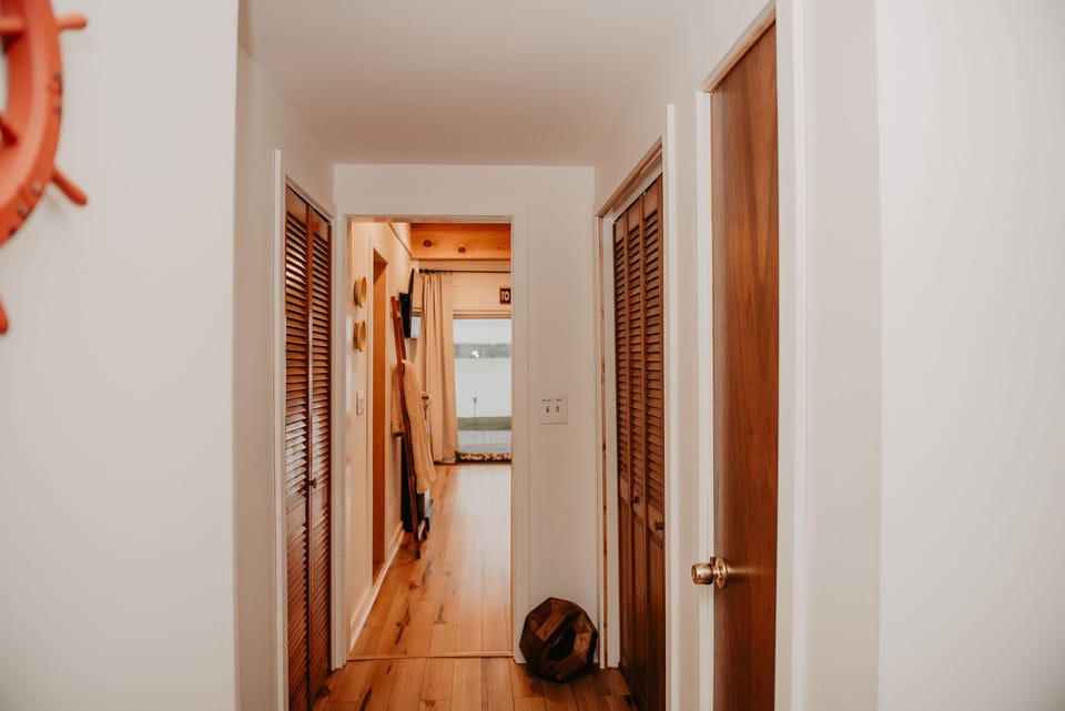 From the moment you walk in, the lake calls. The entry flows into a sunlit living room with floor-to-ceiling views.