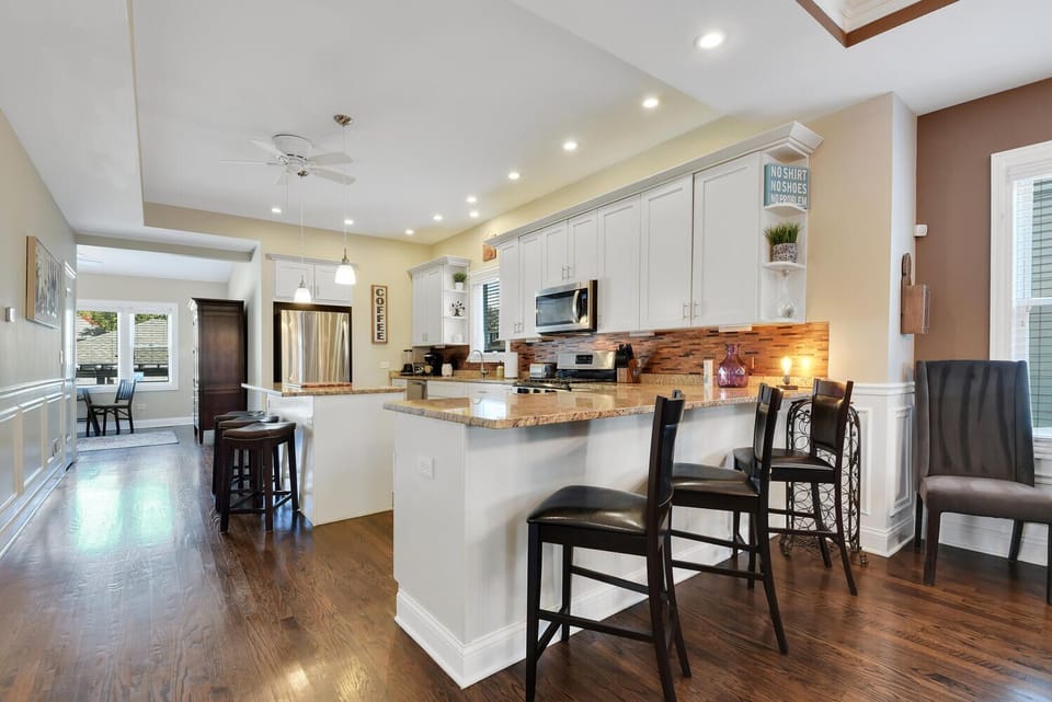 Large kitchen with several bar stools