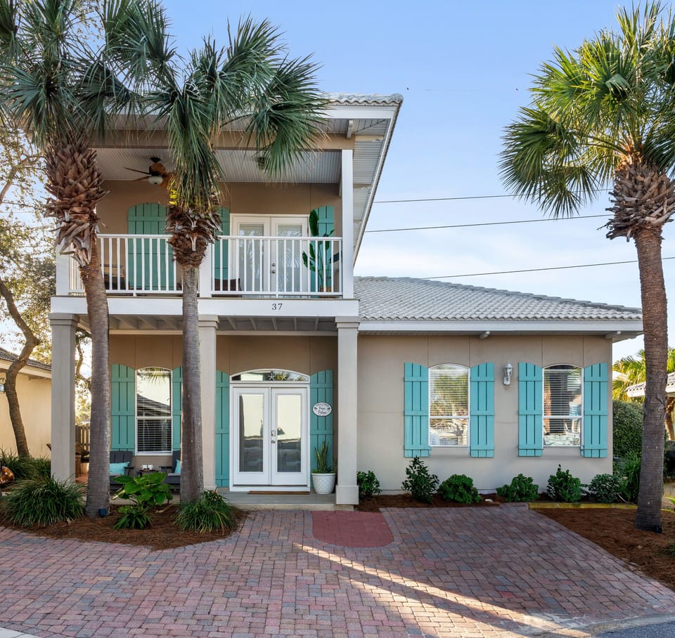 Welcome to Four Palms, a cozy oasis with lush palms and turquoise accents. 