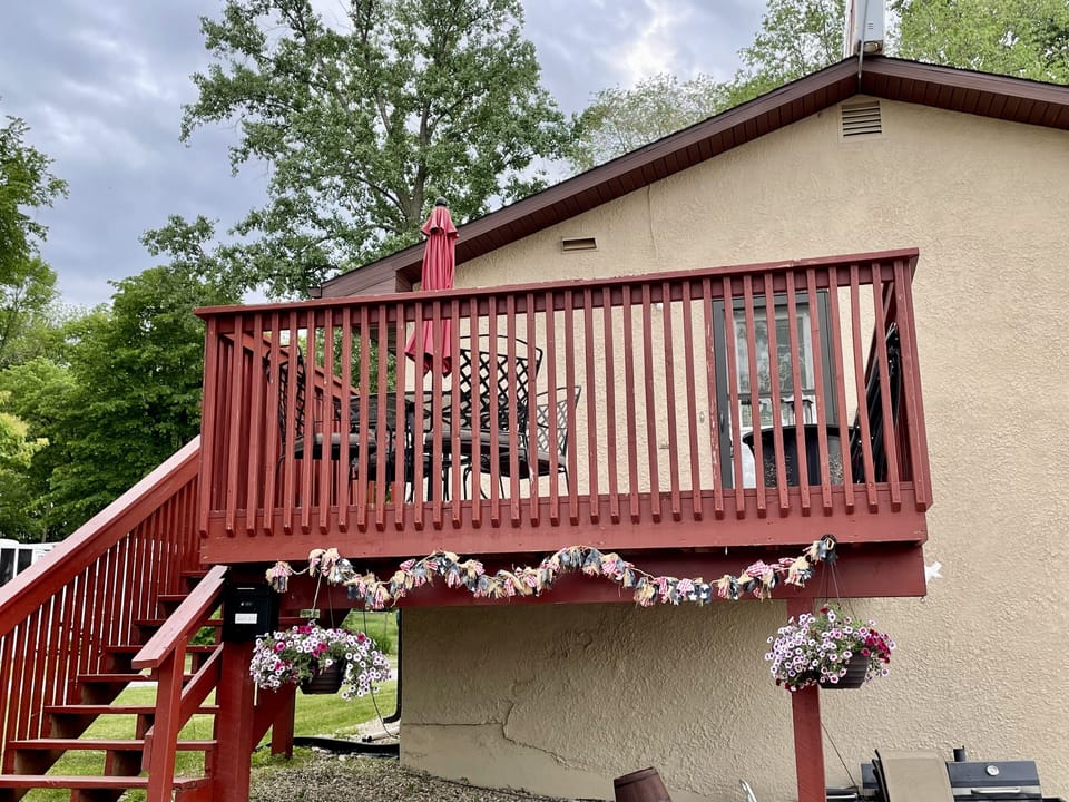 Deck and stairs leading up to the entrance of the upstairs lake house.