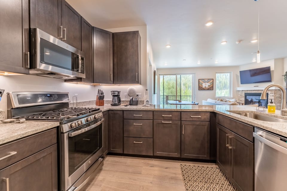 Full size kitchen with high end stainless steel appliances and granite countertops throughout.