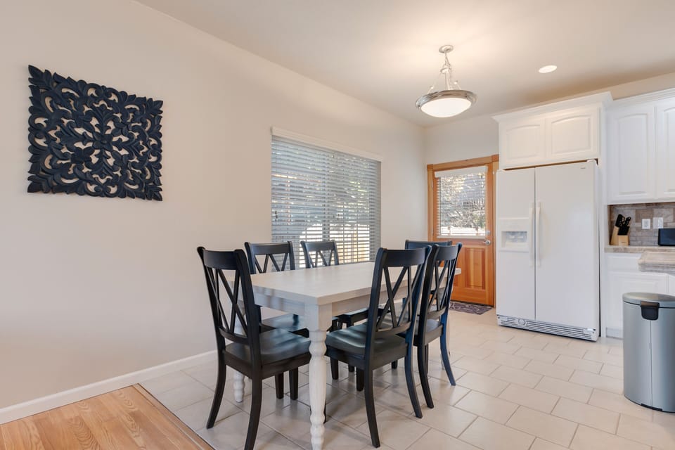 Dining area with access to back patio BBQ, seating and cornhole area.