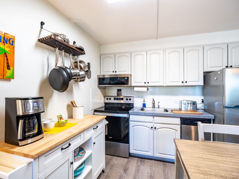 Fully equipped kitchen with quality appliances, pots and pans, and utensils. 
