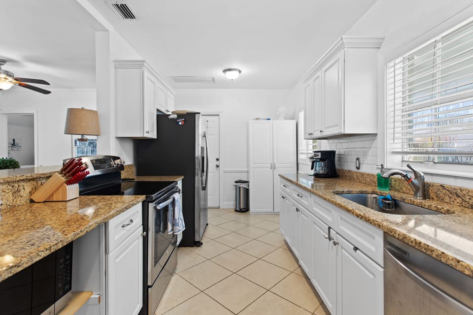 Galley kitchen with an opening, pantry at the end for all the goodies!