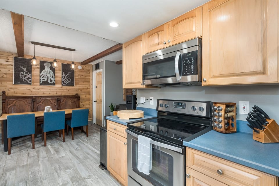 Knives, spice rack, and cutting board to help prepare your meals.
