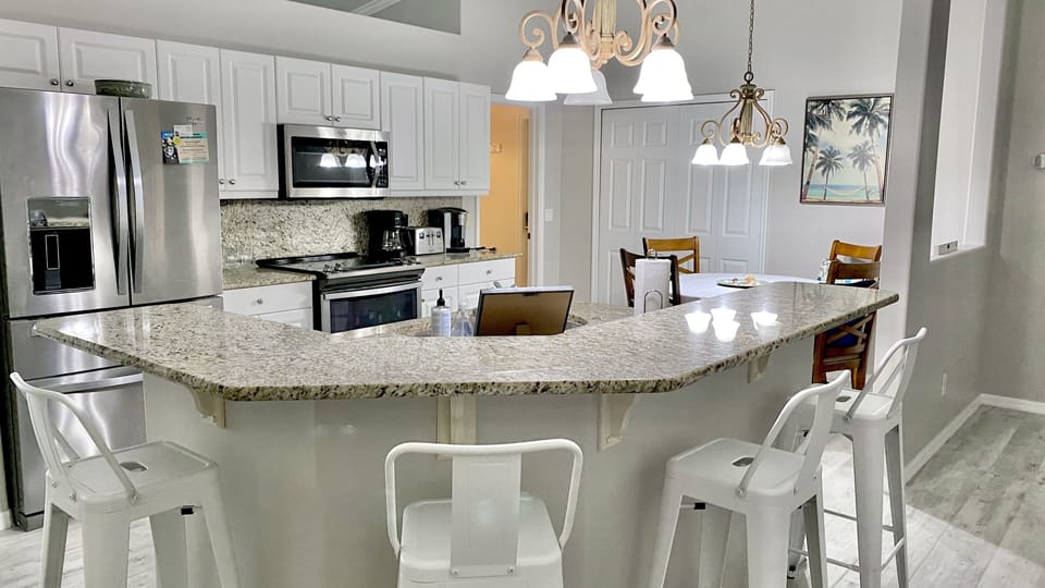Granite breakfast bar easily seats four.