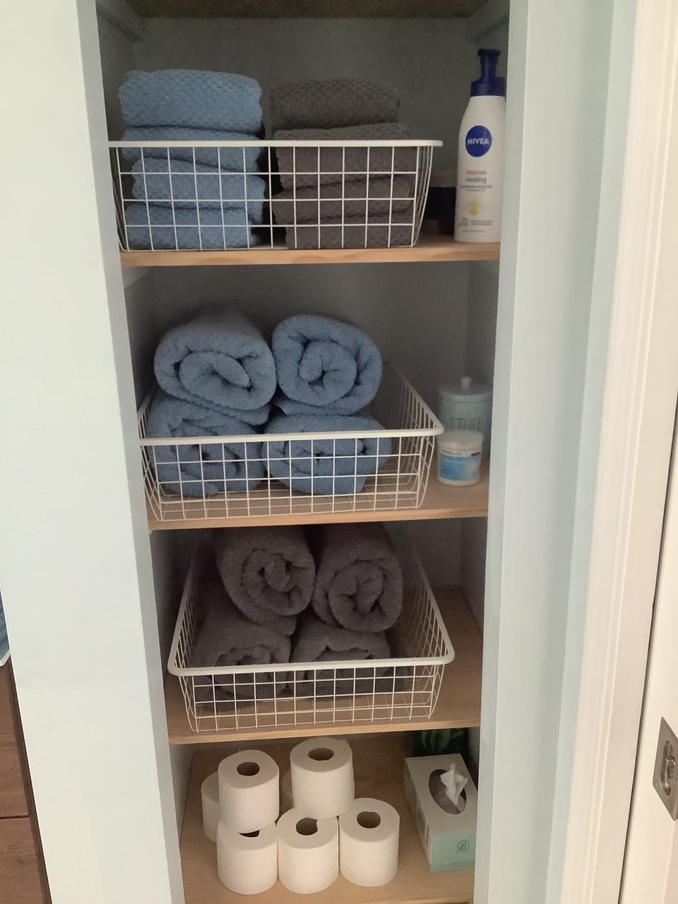 Linen closet stocked for guests with Gap Towels & toiletries