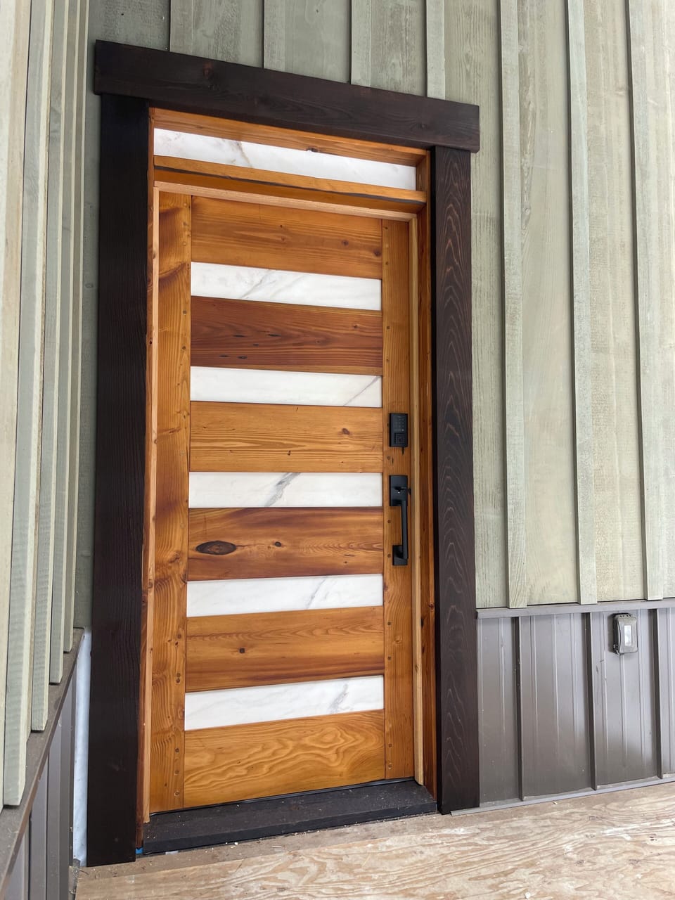 Custom handmade front door with marble inserts at Black Diamond Inn - Glacier WA