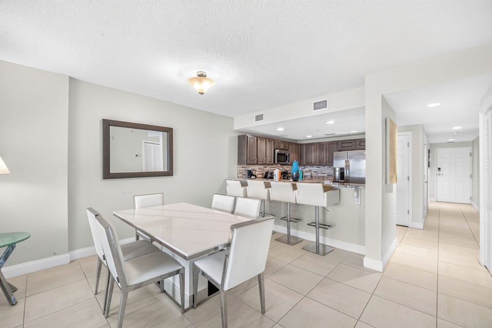 Gather everyone around this spacious dining table that opens beautifully to your fully-equipped kitchen. Clean lines and a bright, airy feel make every meal together feel effortless.