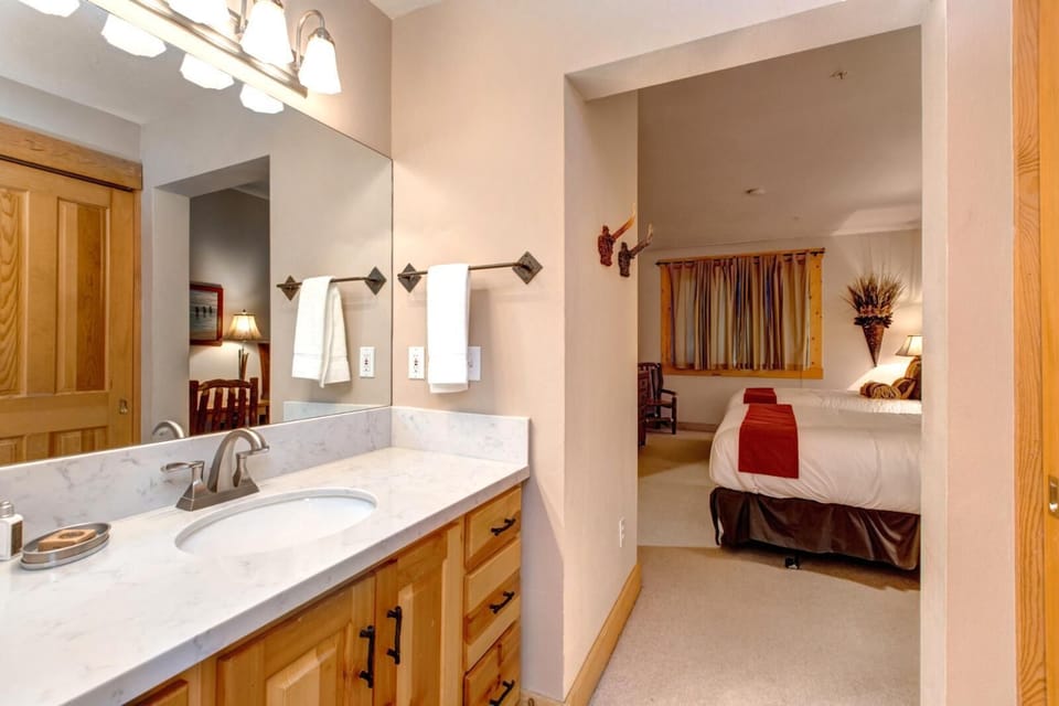 Guest bath includes dual sinks, granite counters, and access from the two-Queen bedroom.
