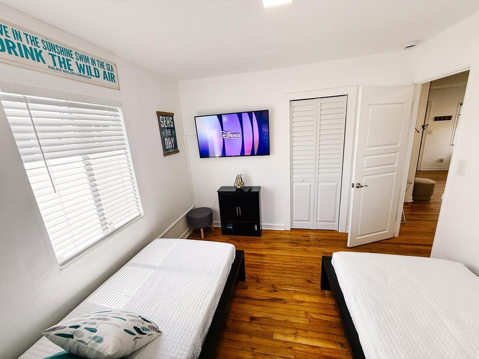 Second bedroom has two comfy twin beds and a TV with Roku, cable, and Disney+. A cozy, bright space where kids can unwind with their favorite shows—great for families or extra guests.