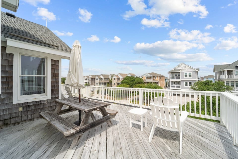 beach house deck close to the ocean.