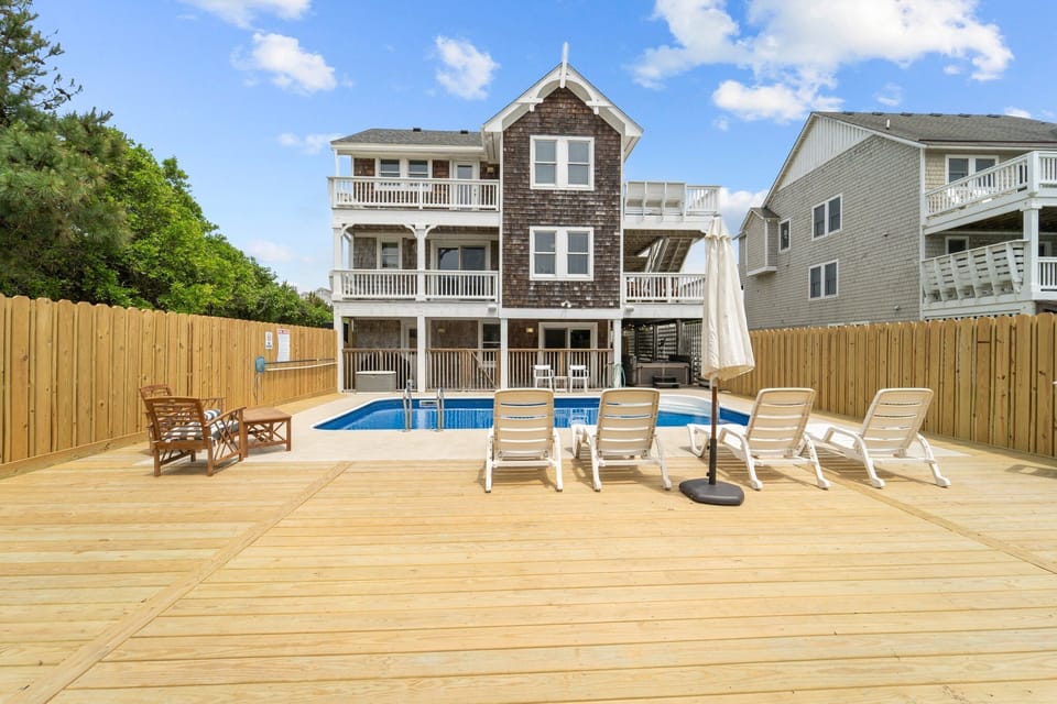 Salt water pool with bluetooth speakers poolside near the beach