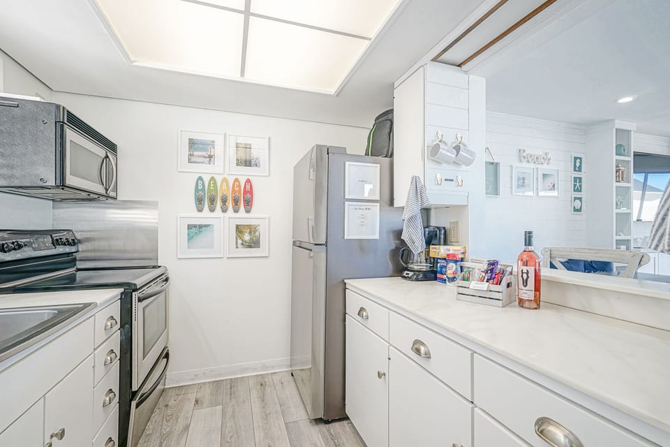 Open kitchen views of the ocean, beach, and sunset with newly updated appliances