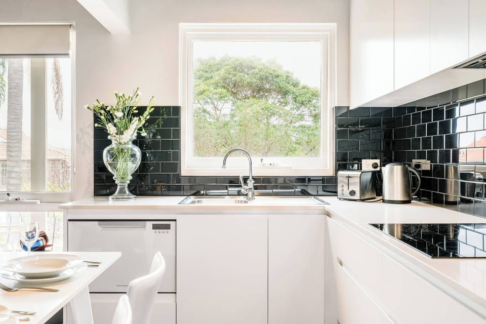 Modern kitchen equipped with a toaster, electric kettle, and dishwasher — everything you need for convenient, hassle-free cooking.