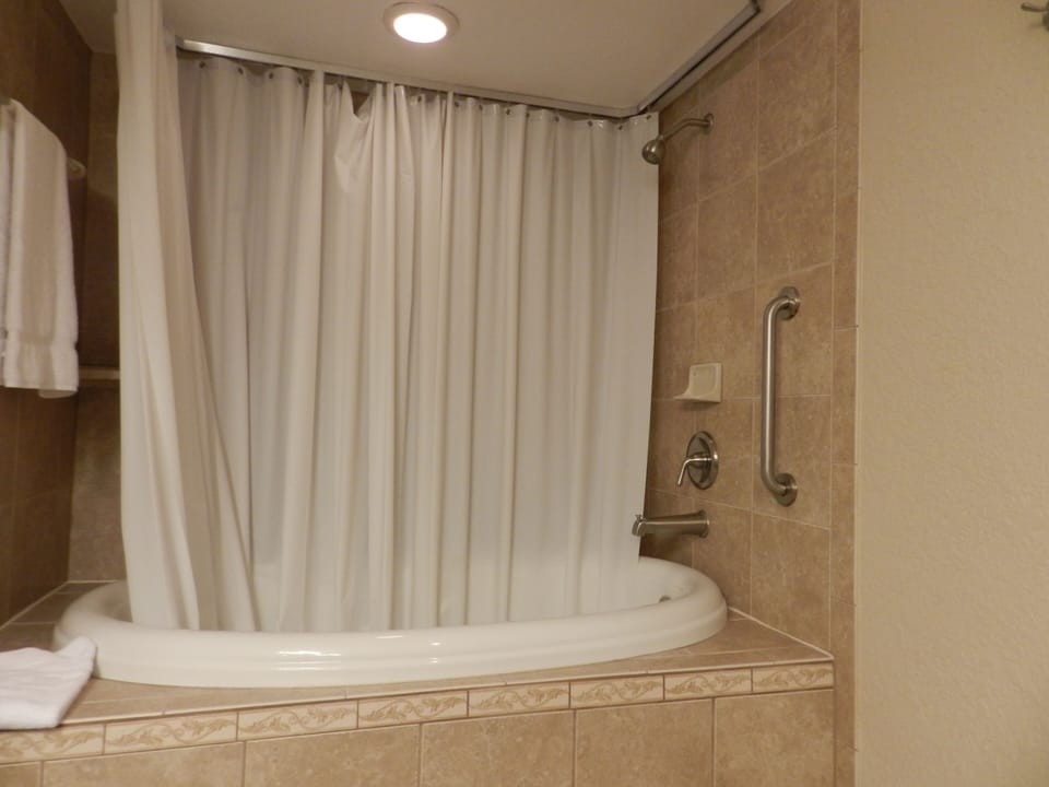 Step into a relaxing shower beside the curved soaking tub.