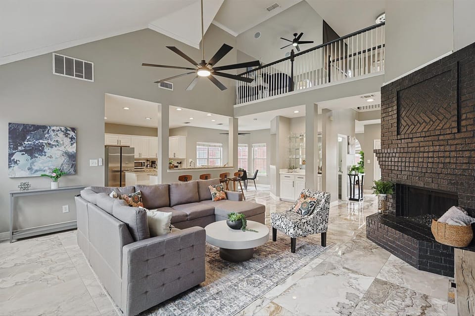 Spacious Modern Living Room with High Ceilings & Cozy Fireplace