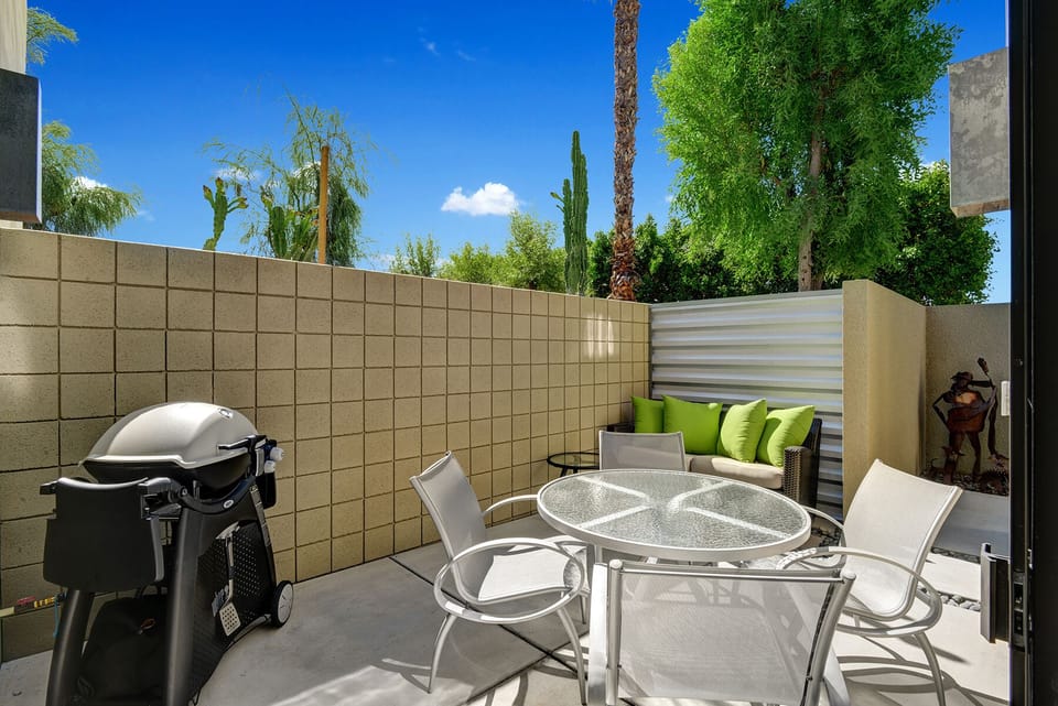 Gas Weber Q, Brown & Jordan love seat, and a Tropitone table round out the patio