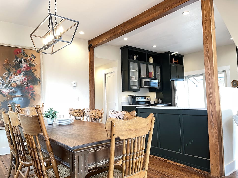 The open main level living, dining and kitchen feature original hardwood floors