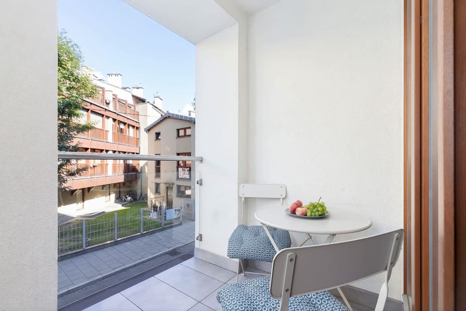 Furnished balcony with table and chairs.