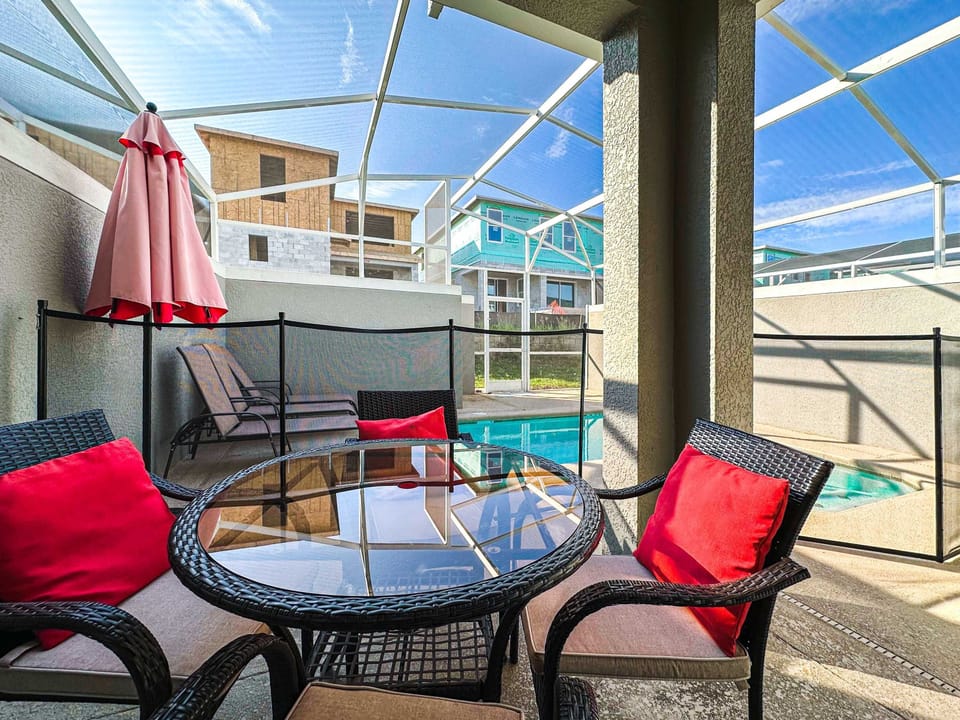 Poolside patio table, offering a perfect spot for leisurely meals and relaxation beside the private pool