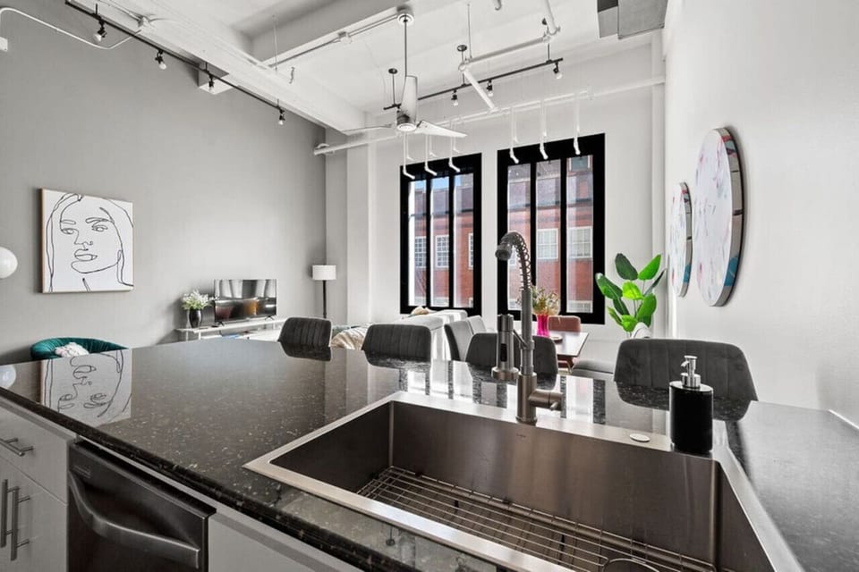 Modern kitchen with a sleek countertop and deep sink — perfect for meal prep or morning coffee.