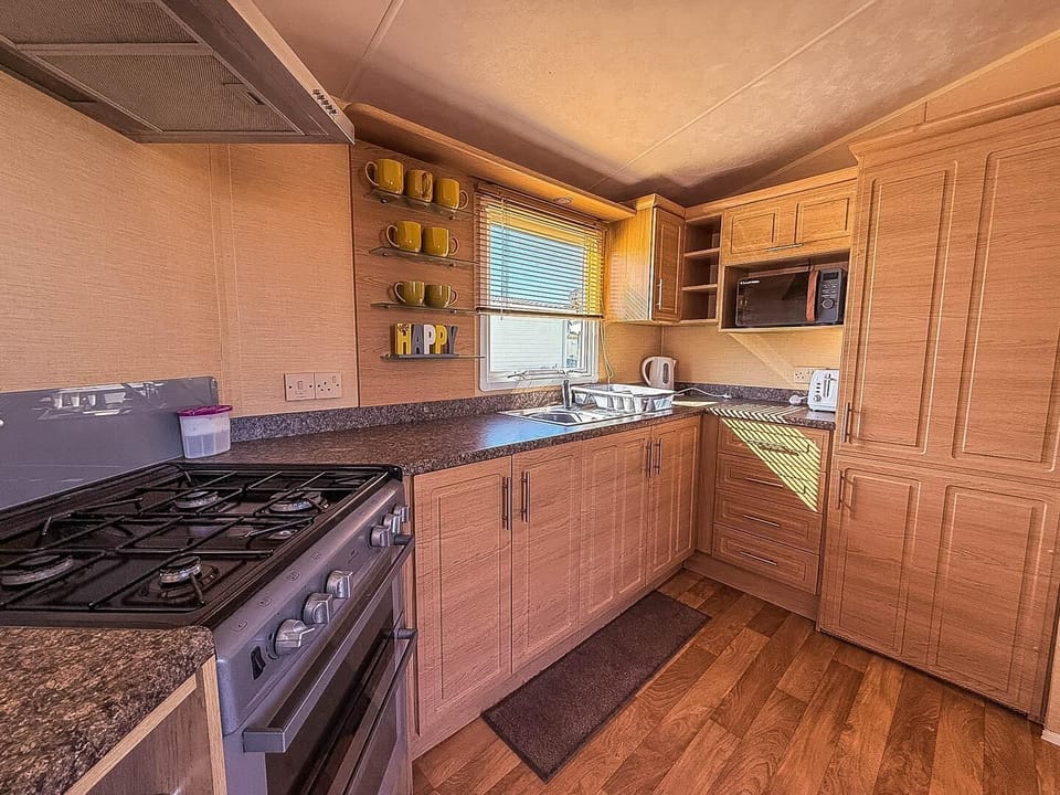 Prepare your favourite holiday meals while still being part of the conversation in this convenient open plan caravan kitchen.