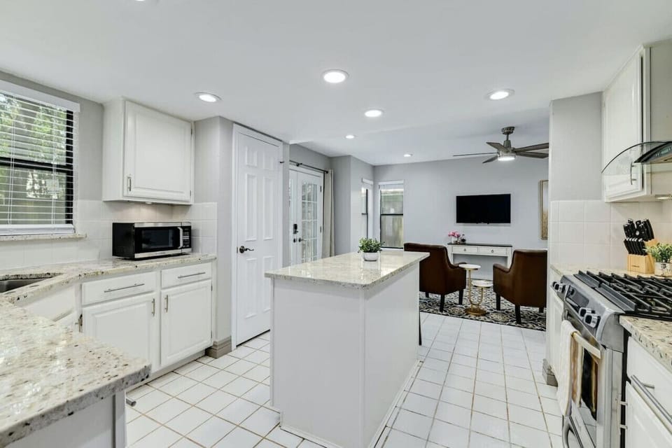 Bright, open kitchen flows seamlessly into living space, perfect for connection and comfort with A Stay Above The Rest.
