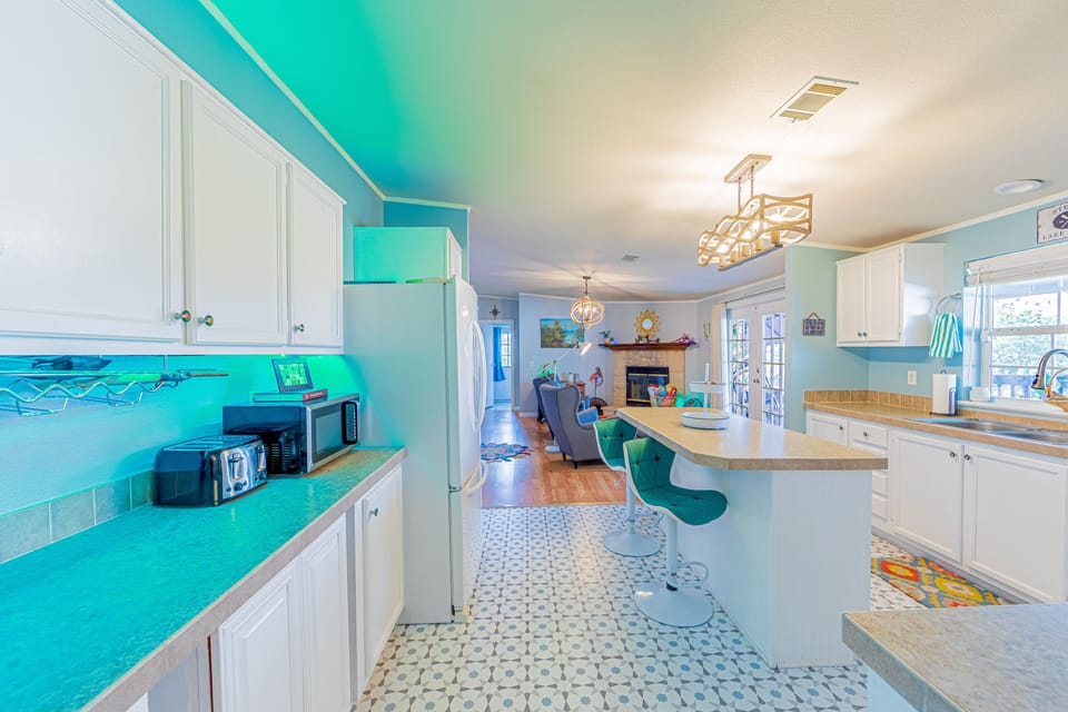 Light and bright kitchen with tons of cabinets and lots of amenities.