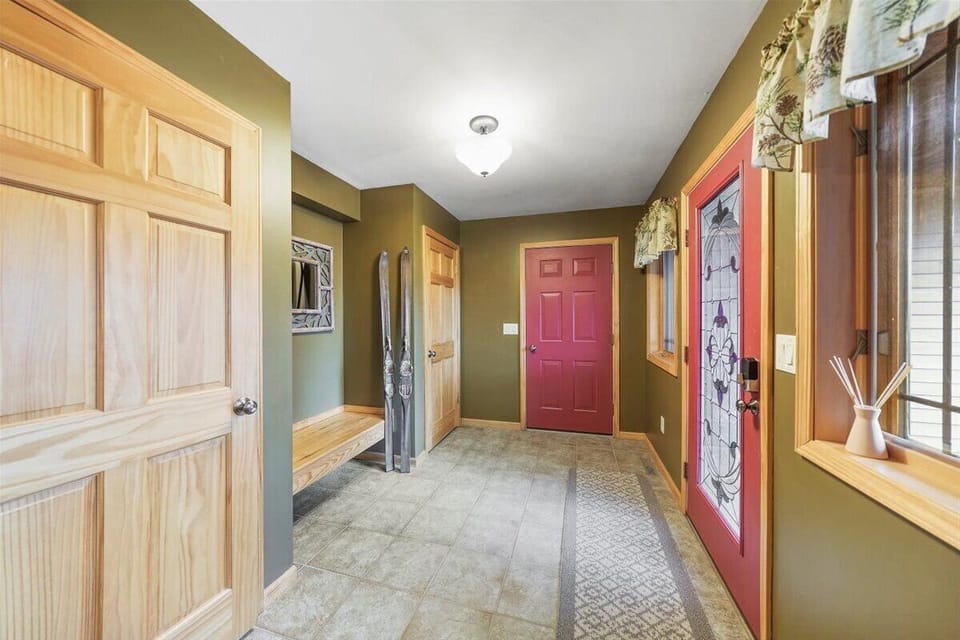 Entry way foyer and door leading into garage and access to additional suite.