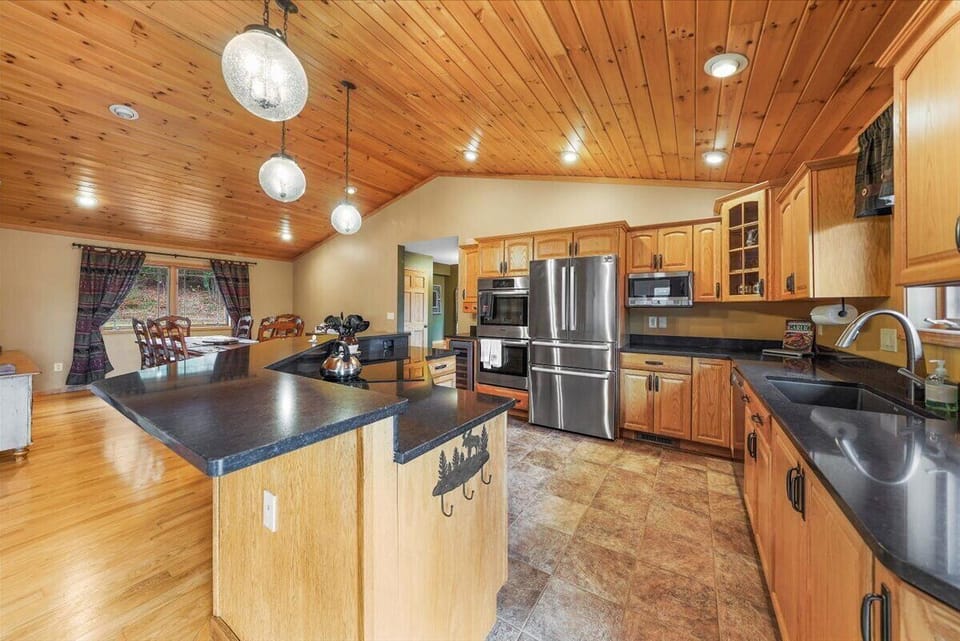 Double oven Kitchen with high-end appliances and dining area.