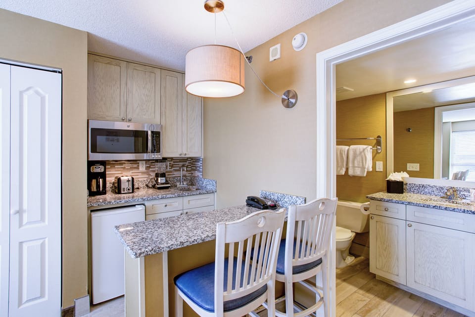 Cook and snack easily with granite counters and handy appliances.