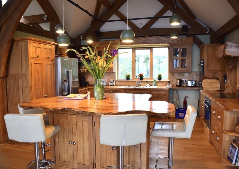 the spacious well-equipped kitchen has large central island and breakfast bar