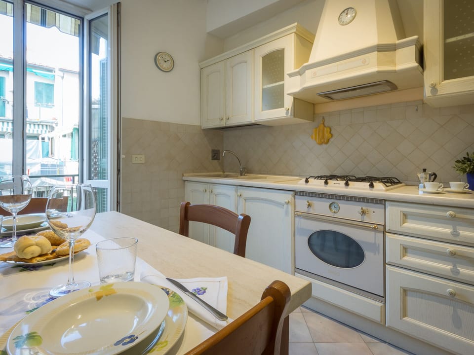 The fully equipped kitchen opens to the small balcony with the washing machine. 