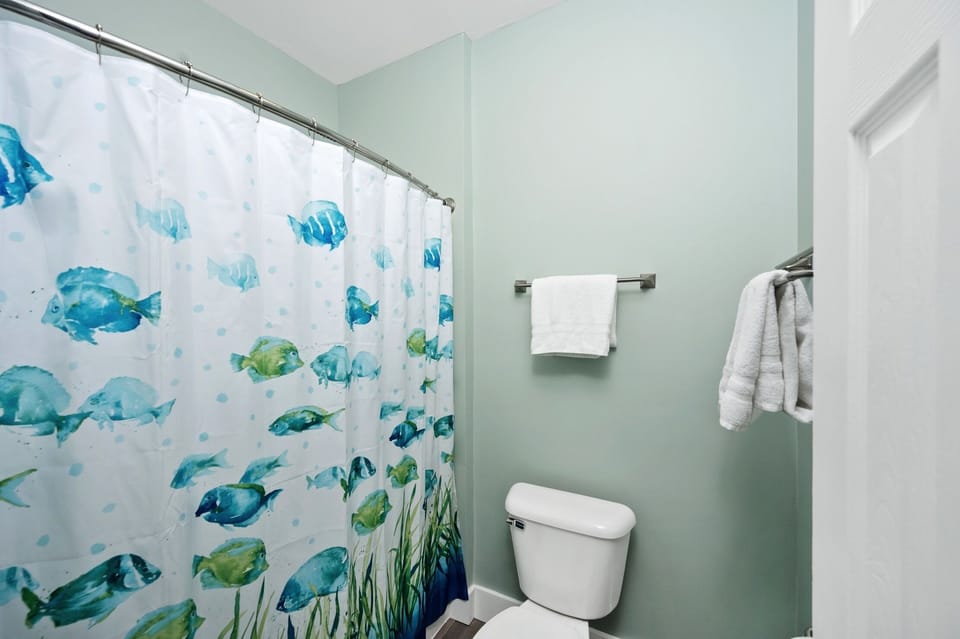 Master shower and toilet with door for privacy from bathroom sink and closet. 