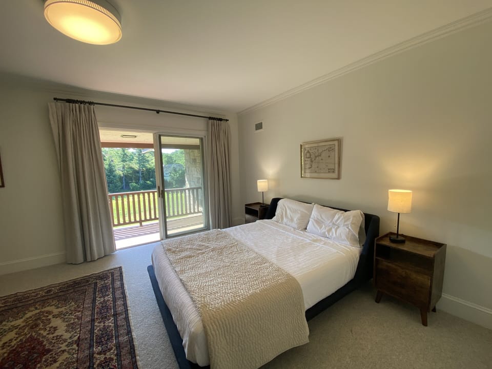 Explorer Bedroom with slider door open to balcony which overlooks the Great Lawn
